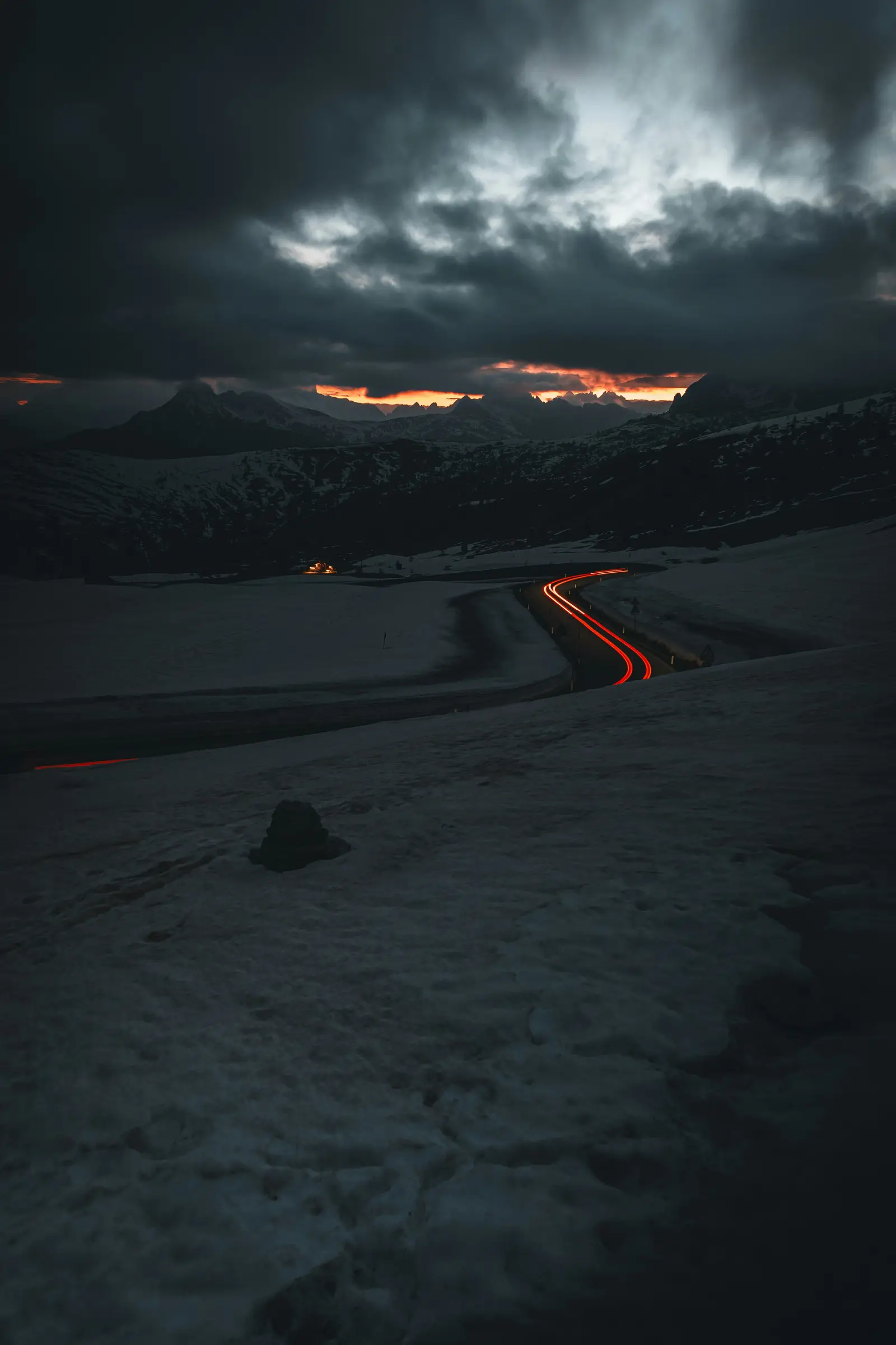 a road that is in the middle of some snow