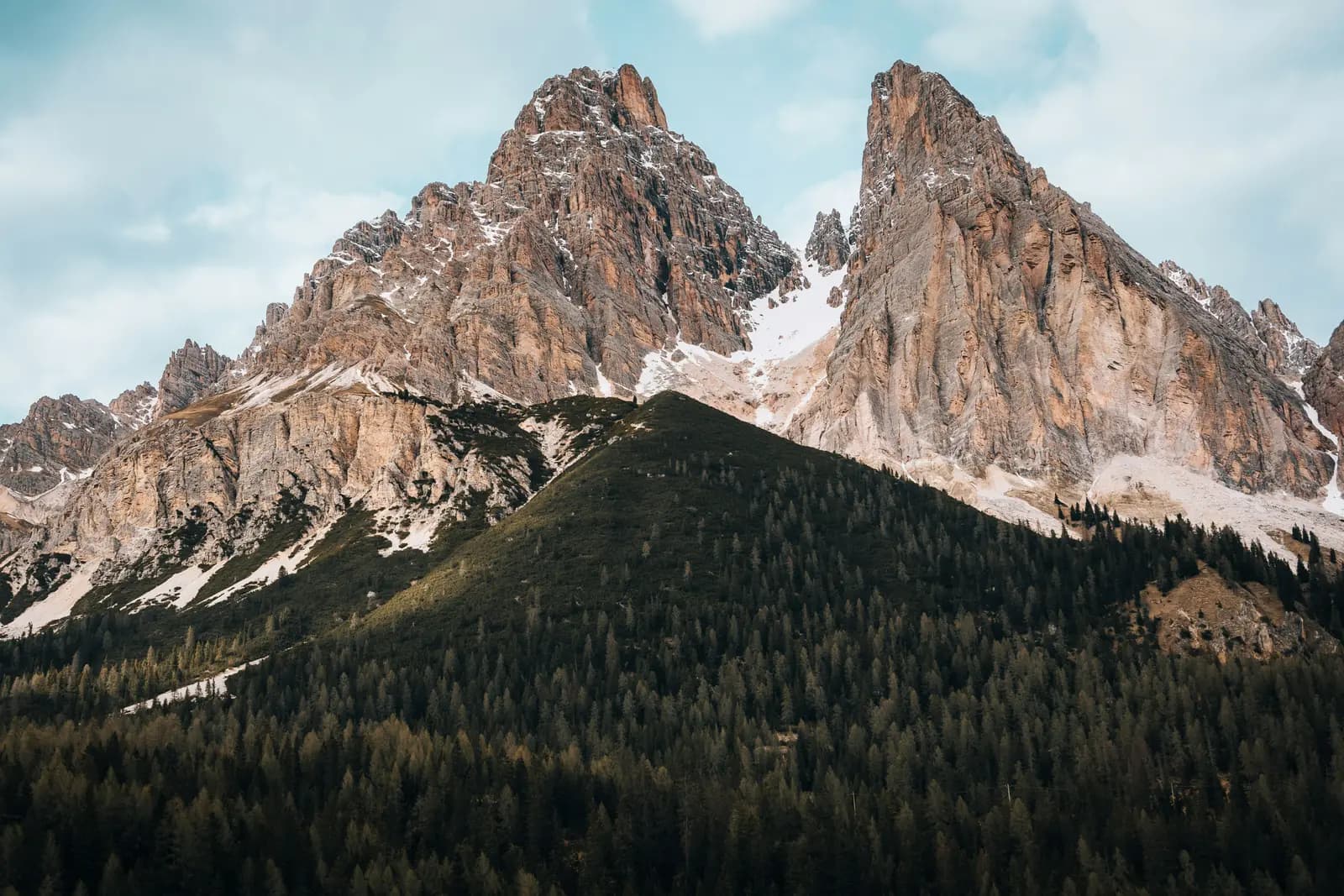 a mountain range covered in snow and trees